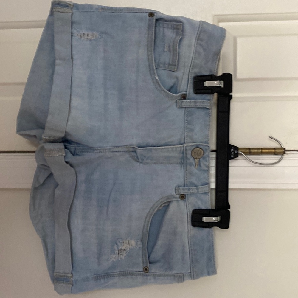 Light blue stretch denim cuffed ripped jeans